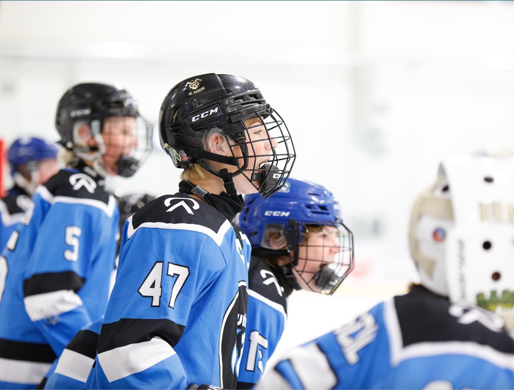Blue-jersey teammates watch the action together at UMH-68.